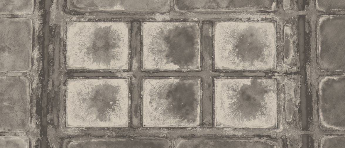 Crystallisers 6a to 6f from 300 metres: six small square pans in two rows of three, salt crust whitening each one from its edges inward.