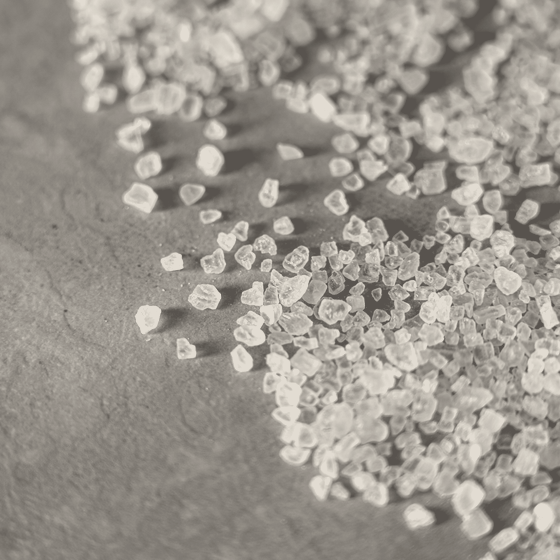 Flake salt: hollow pyramid crystals heaped together, the largest about five millimetres on a side.